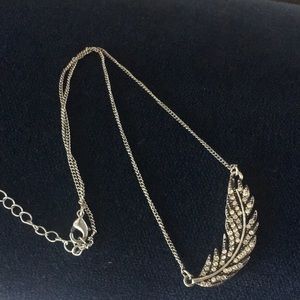 Silver feather necklace.